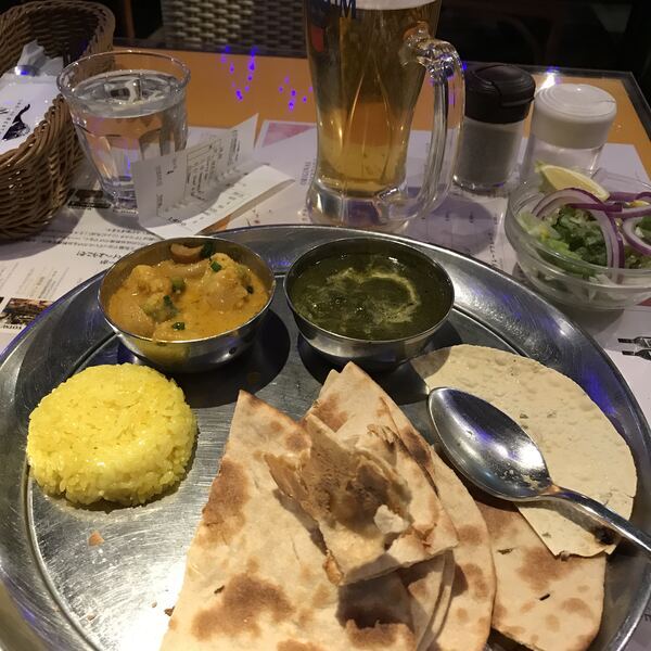 Full Indian thali with assorted curries, rice, roti and sides